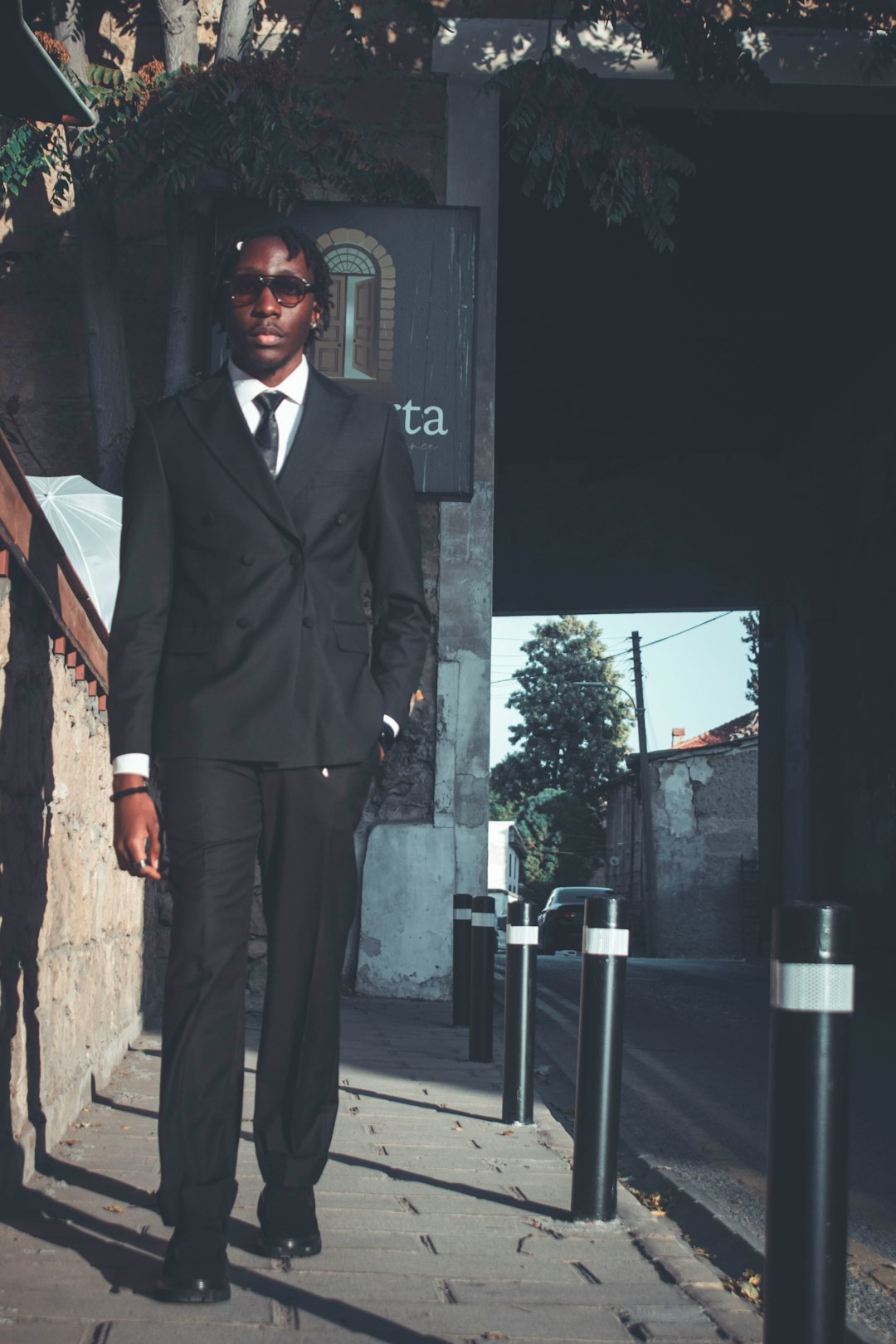 Young black man in a suit walking outside